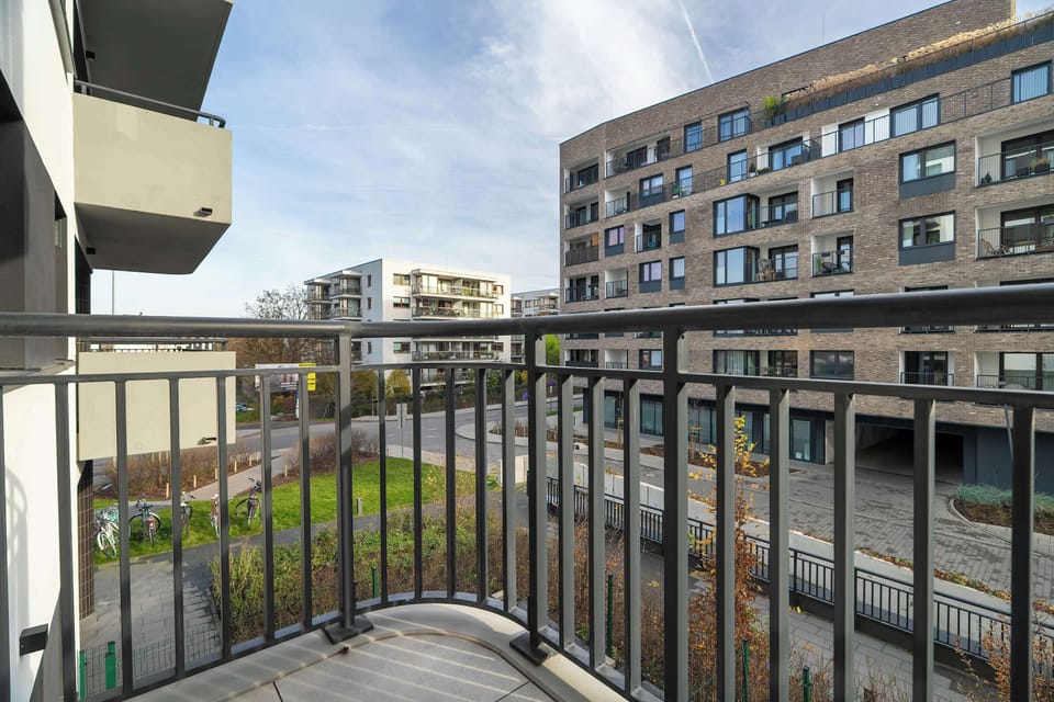 Private balcony overlooking modern residential buildings
