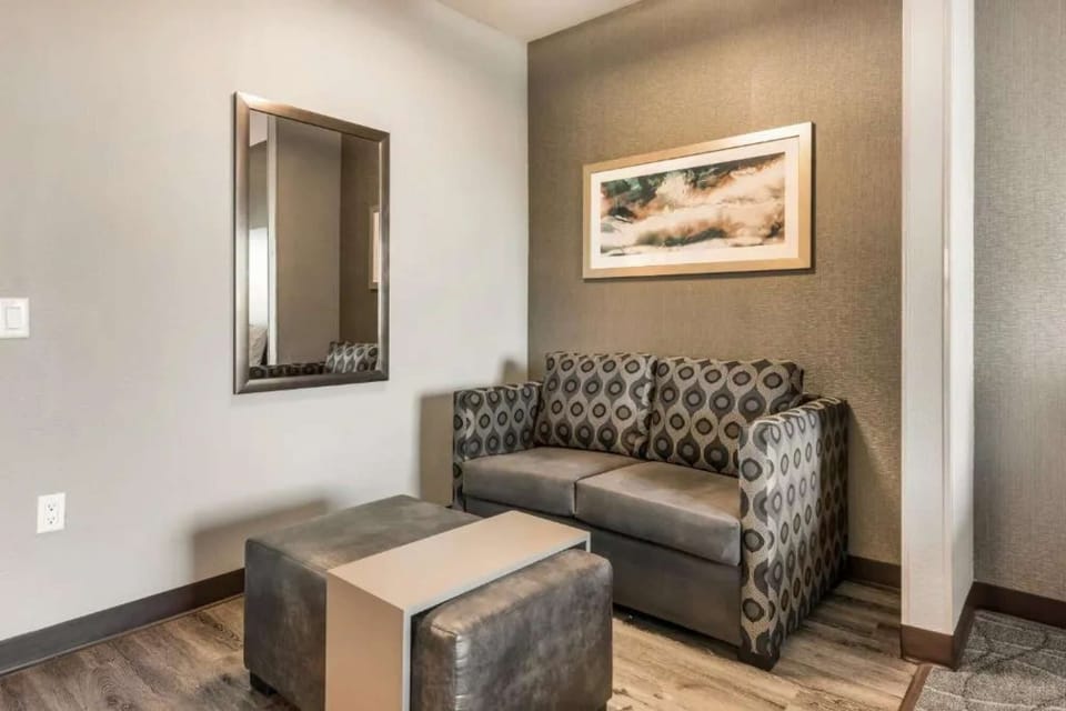 Cozy corner with pull-out sofa bed and small ottoman table