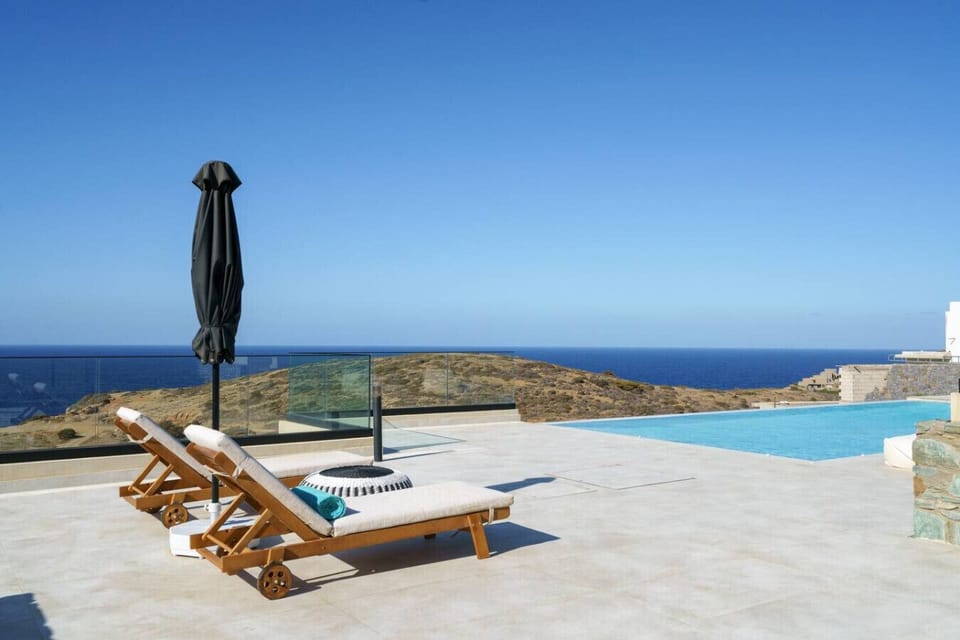 Enjoy a luxurious pool experience with comfortable loungers and umbrellas.