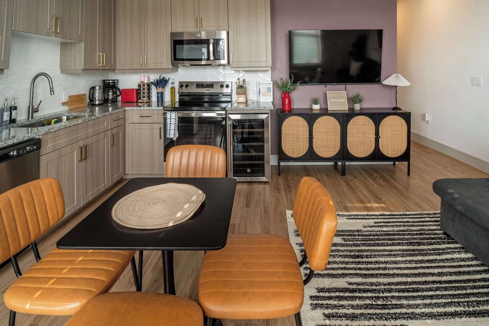 Fully equipped kitchen with stainless steel appliances, ample counter space, and a dedicated dining table. Ideal for both short and extended stays, offering everything needed for everyday cooking and dining.
