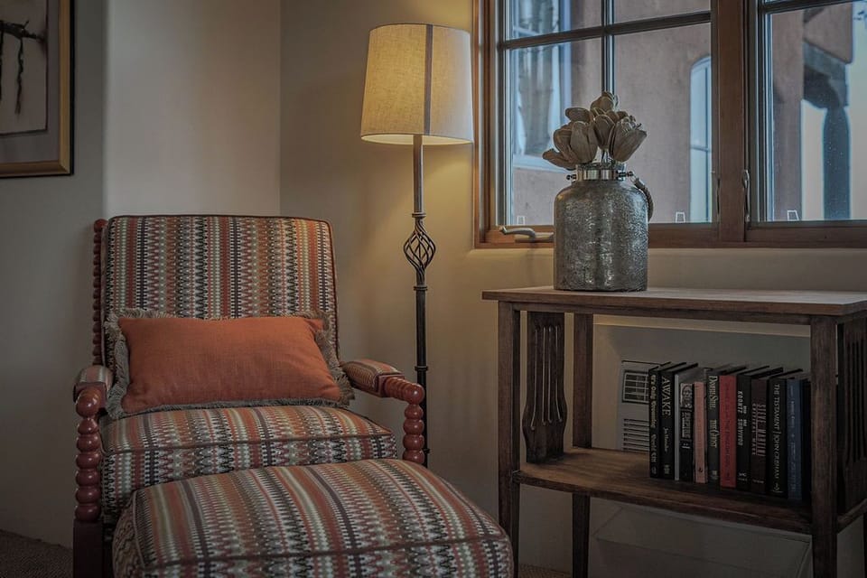Curl up in your cozy reading chair with a good book, warm lamp light creating the perfect atmosphere for relaxation.