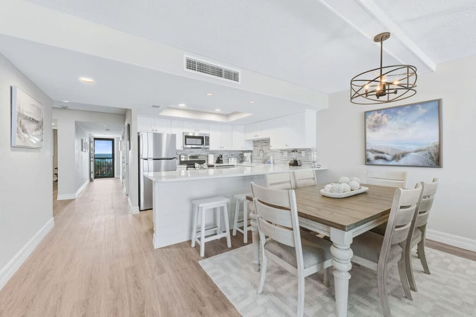 The dining area seamlessly blends the distressed wood look of yester-year with the incredibly modern chandelier.