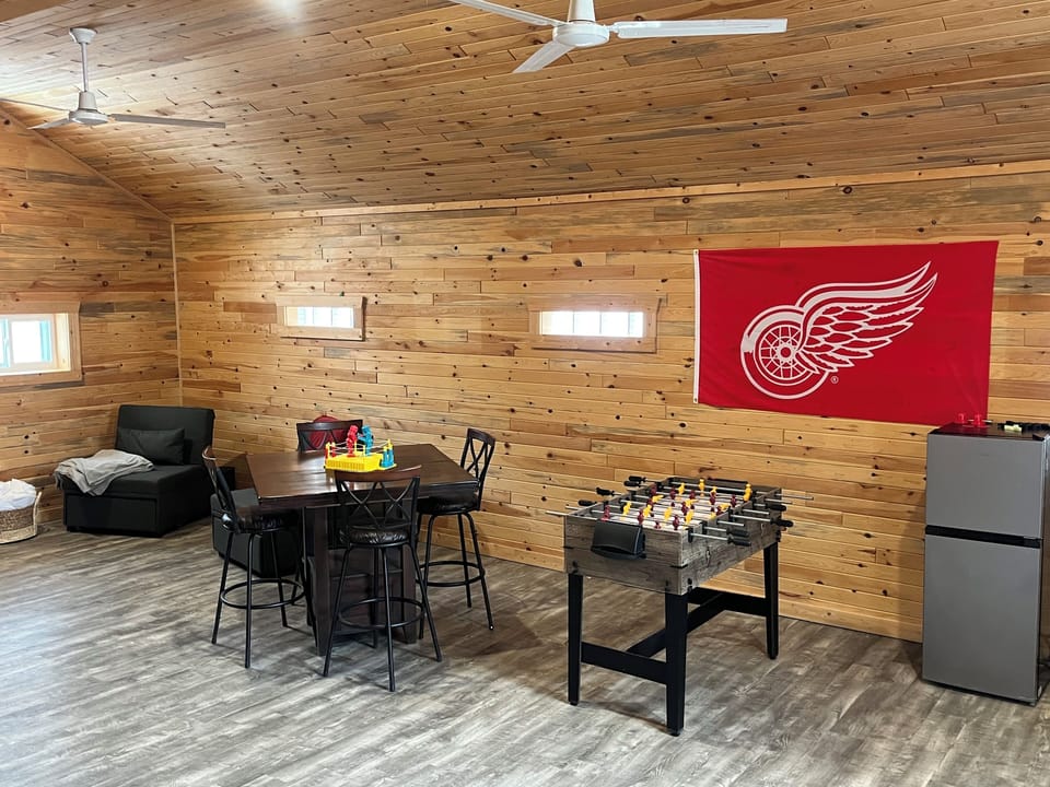 Large game room with 3 in 1 game table, mini fridge, games and smart TV