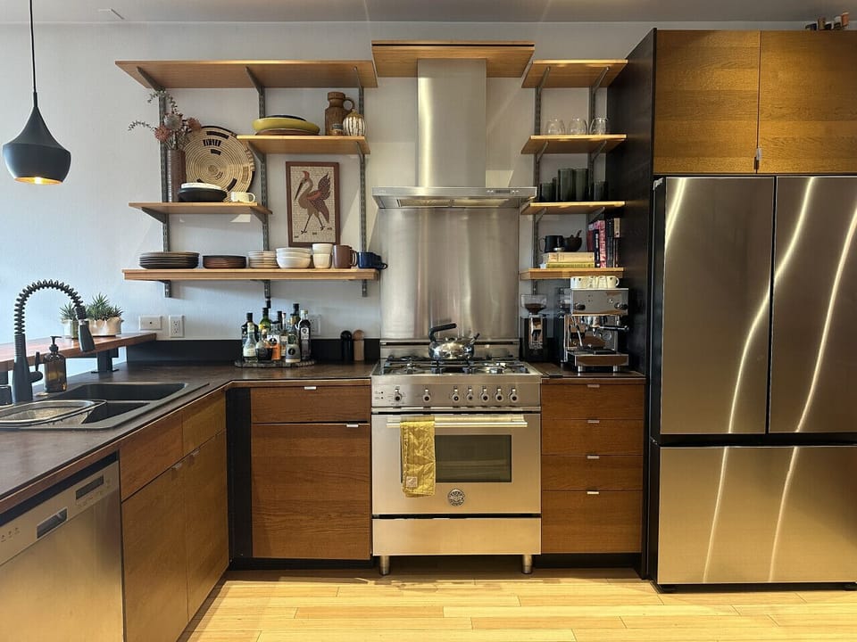 Chef`s kitchen featuring high-end appliances and cookware