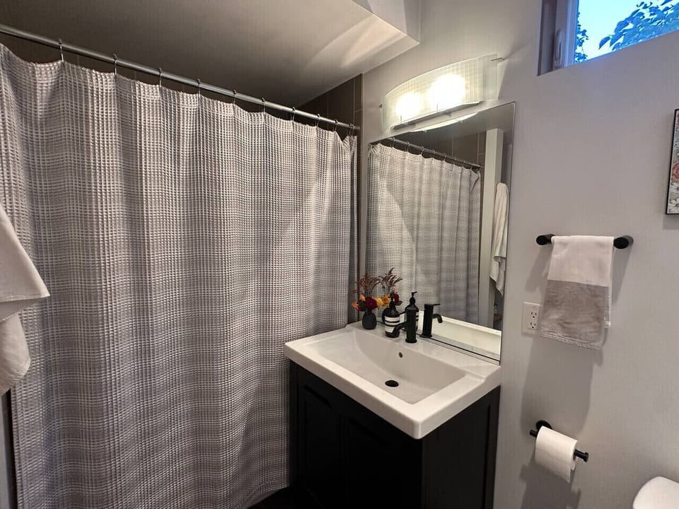 First floor bathroom features bathtub and shower and is easily accessible to Bedroom2.