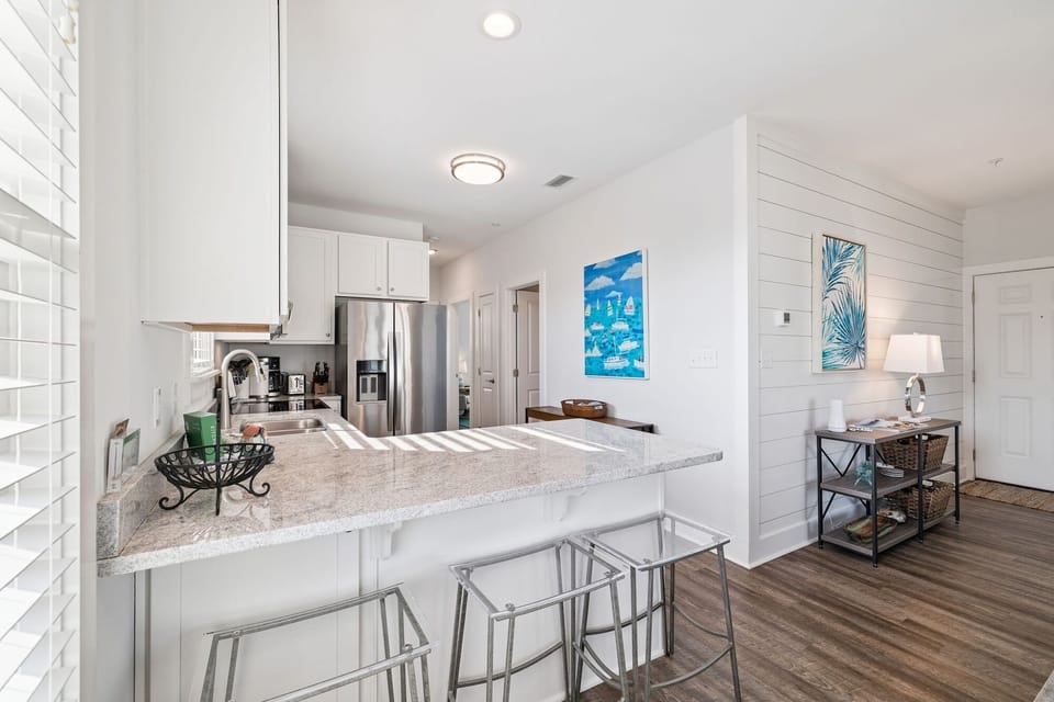 Your sleek kitchen features granite counters, stainless appliances, and a breakfast bar where you can enjoy coffee in natural light.
