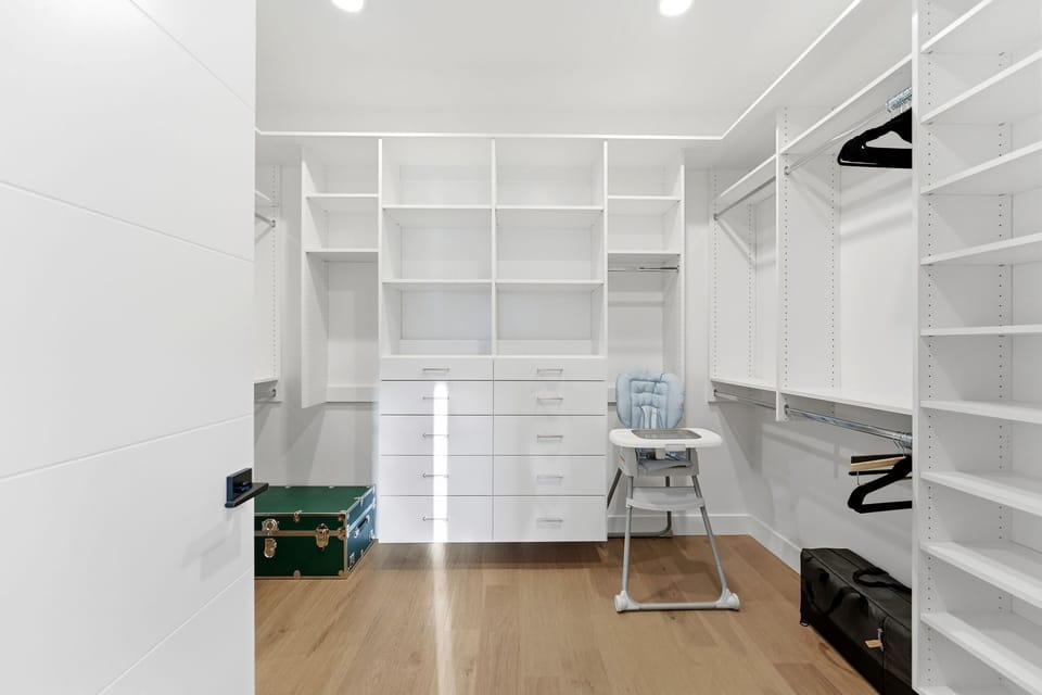 Spacious walk-in closet with custom shelving