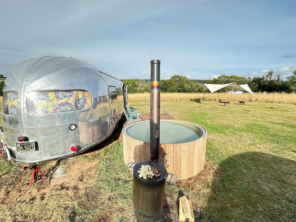 Side-on view of the Airstream, tub and wood-fired stove.