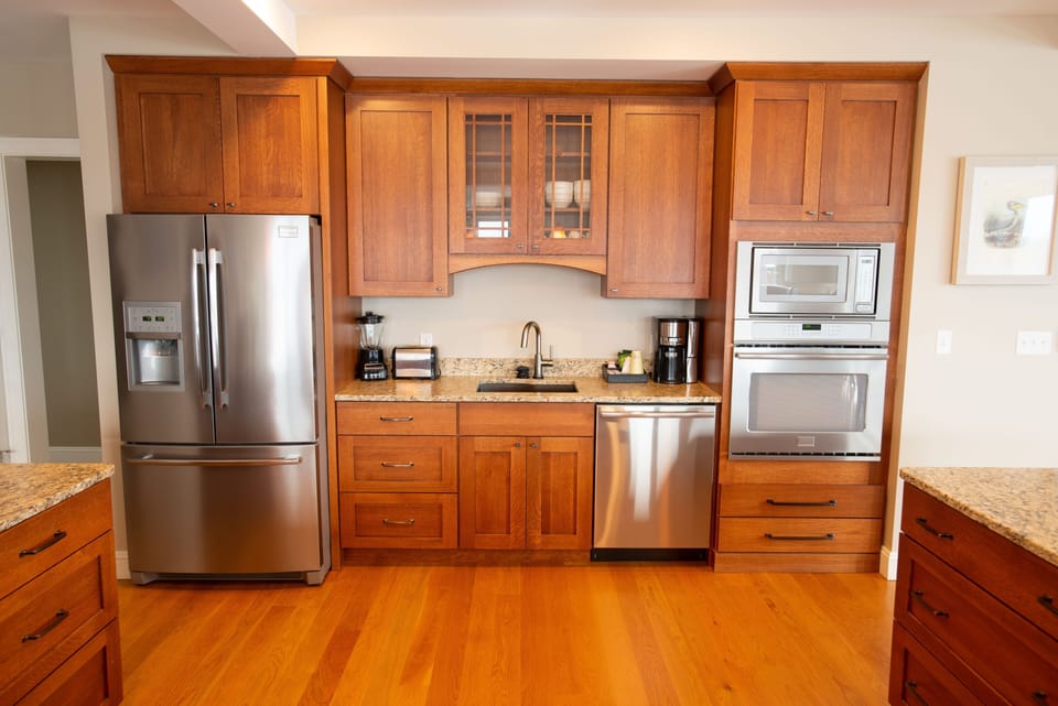 The sophisticated kitchen setup features premium appliances and ample storage, creating an inviting atmosphere for culinary creativity while being bathed in natural light.