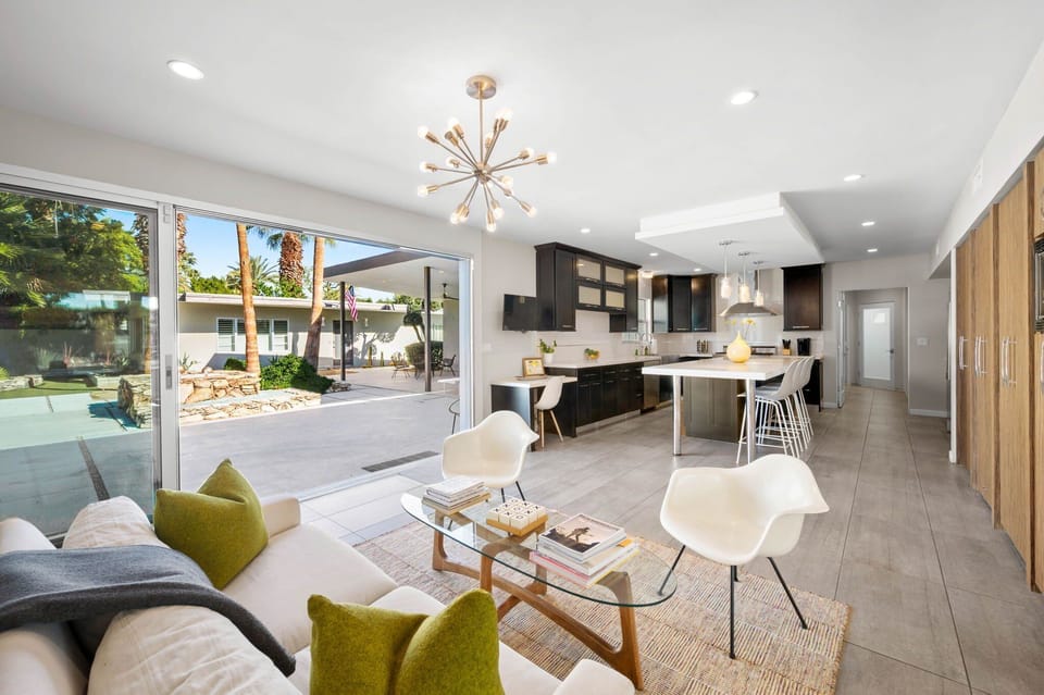 Inviting open lounge space just off the kitchen, perfectly positioned between the large sliders to the pool and the dining room. A great spot to relax, gather with friends, or enjoy the indoor outdoor flow of the home.