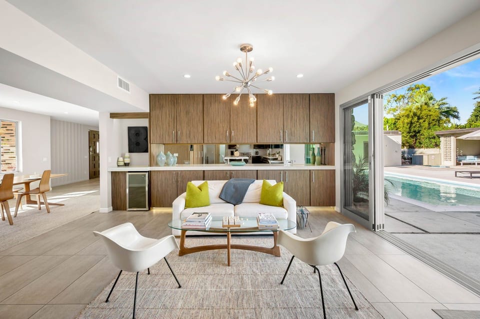Inviting open lounge space just off the kitchen, perfectly positioned between the large sliders to the pool and the dining room. A great spot to relax, gather with friends, or enjoy the indoor outdoor flow of the home.