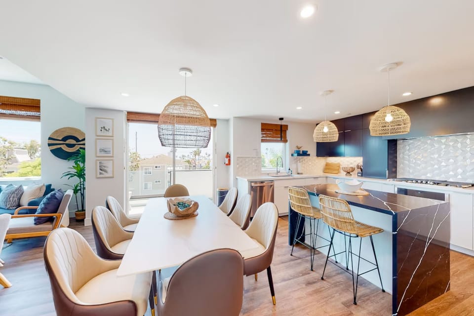Enjoy meals together at this stylish dining area with contemporary seating and easy access to the kitchen. Perfect for family dinners, game nights, or planning your next beach adventure just minutes from the ocean.