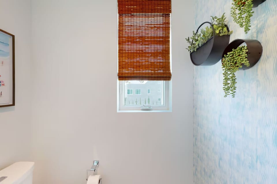 Refresh and unwind in this modern bathroom featuring a walk-in shower, sleek fixtures, and bright coastal design. Perfect for starting your day before hitting the beach or relaxing after a day of exploring Oceanside.