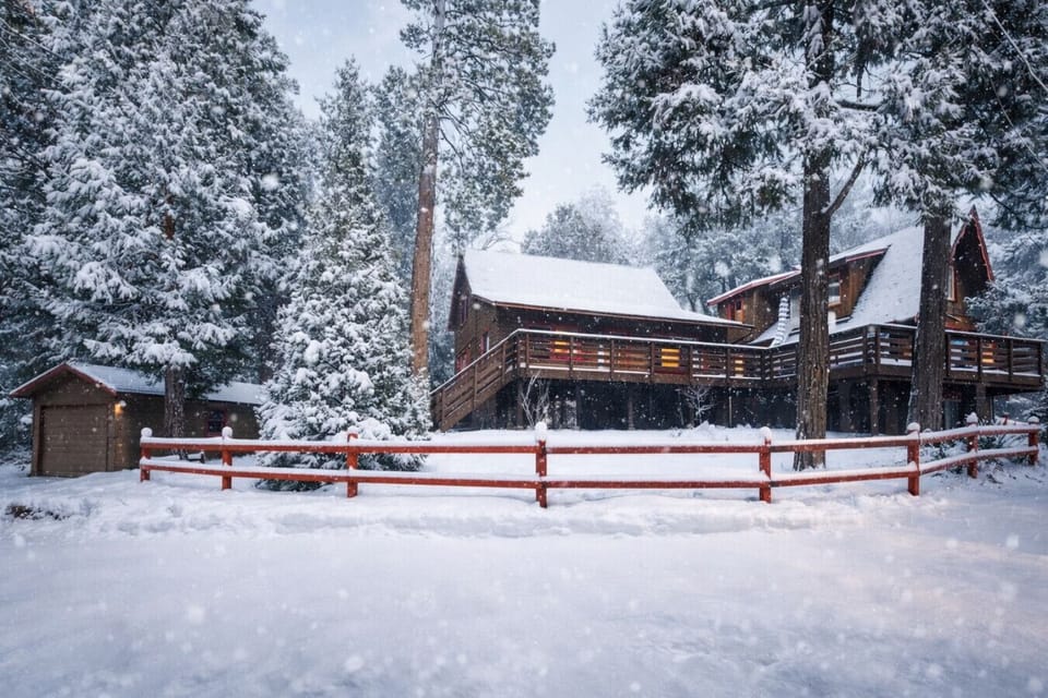 Peaceful mountain retreat surrounded by tall pines and seasonal snowfall.