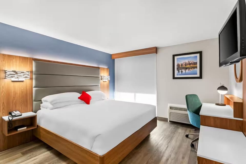 Unwind in a bright king bedroom with workspace and TV.