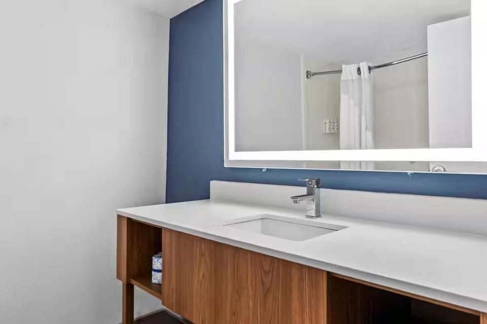 Refresh at a bright vanity with clean, modern lighting.