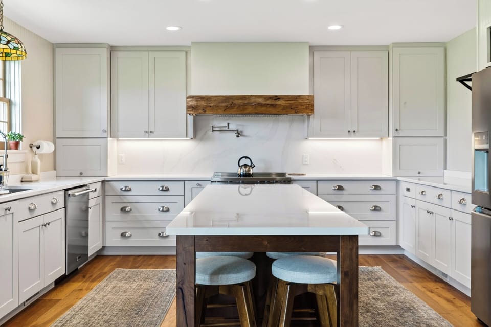 Bright farmhouse kitchen with a large island, rustic beam details, and plenty of space for group cooking.