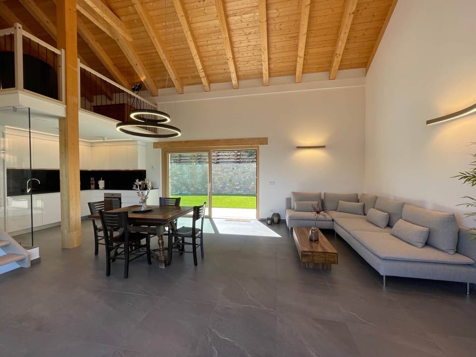 PEPPOLA - Open modern kitchen and living area with comfortable sofa