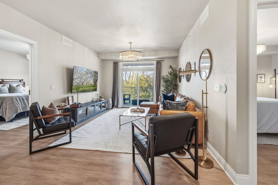 Light-filled open living area with direct access to the expansive wrap-around balcony and fire table