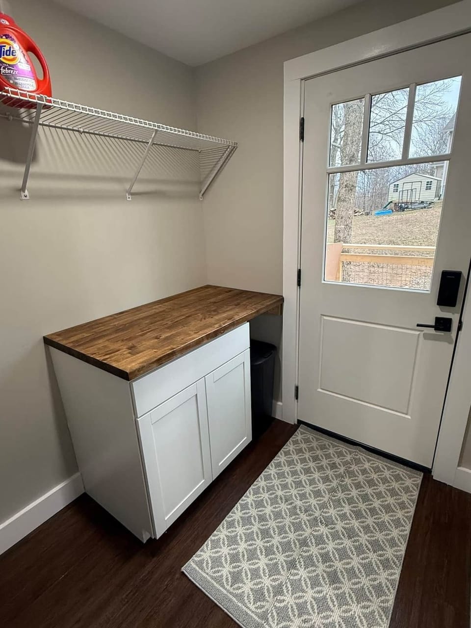 Laundry room - extra hanging space + counter space to fold clothes. Access to side porch with keypad