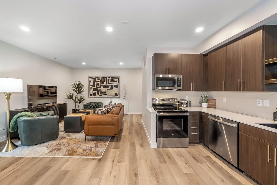 Relax in your modern open-plan space with sleek kitchen, cozy seating, and stylish decor creating the perfect home base.