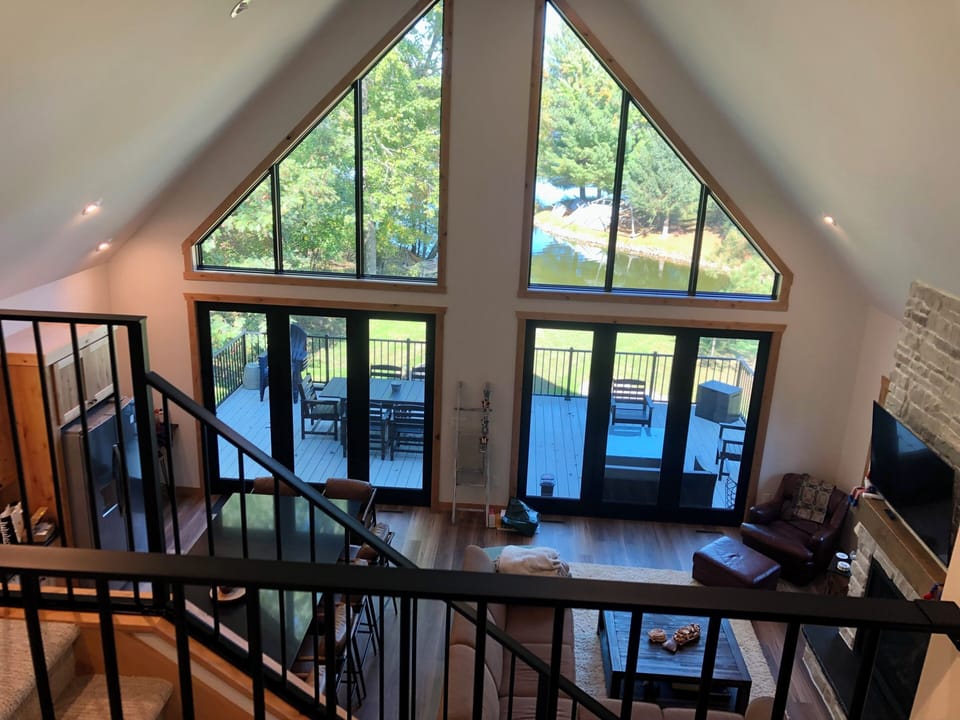 Open living room and kitchen. Vaulted ceiling with gorgeous views of lake!