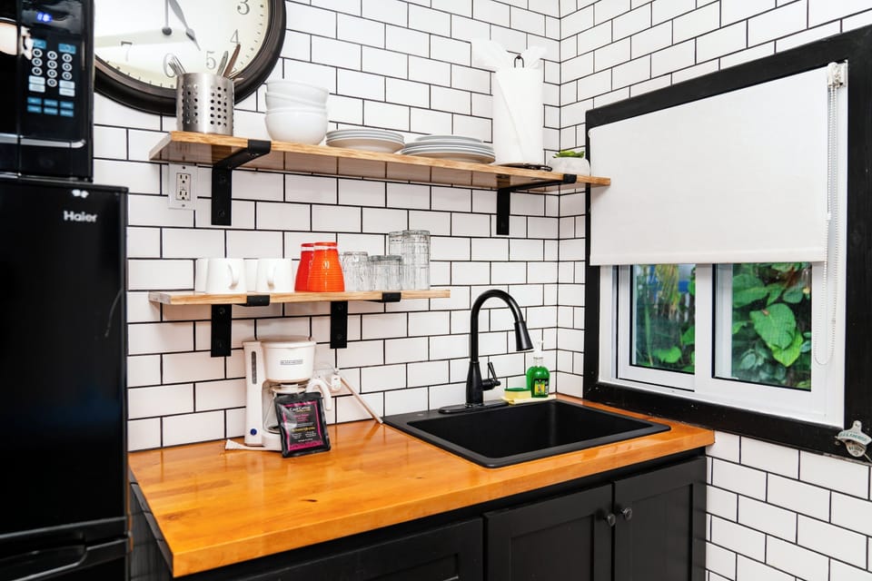 Your stylish kitchenette features refrigerator, coffee maker, sink, hot plate and open shelving to make meal prep feel effortless and inviting.