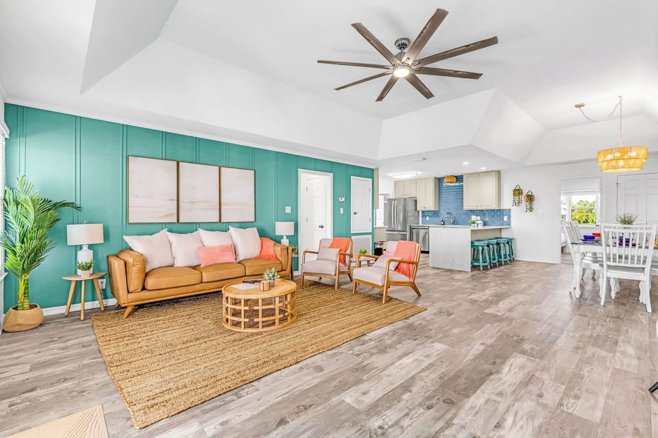 Cognac leather couch, Roku TV, seating, and boho inspired accents throughout.