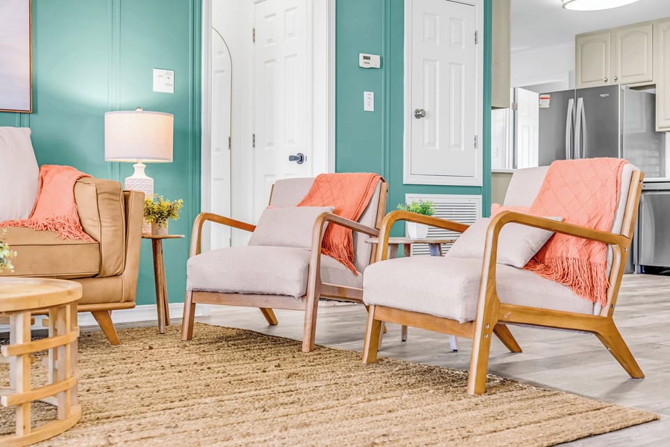 Cognac leather couch, seating, Roku TV, and boho inspired accents throughout.