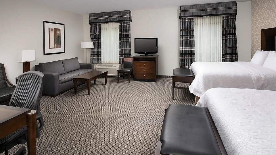 Spread out in a spacious suite with lounging and extra beds.