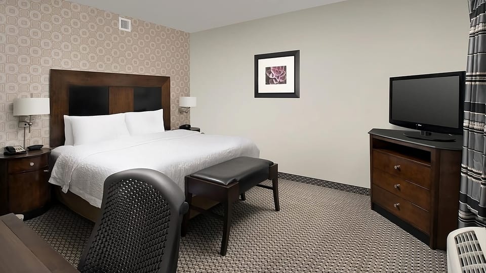 Unwind in crisp linens on a plush, restful bed.