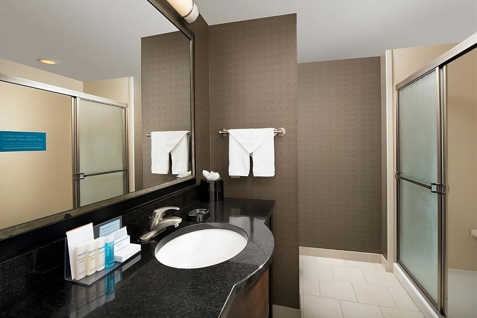 Refresh effortlessly with a sleek vanity and bright mirror.
