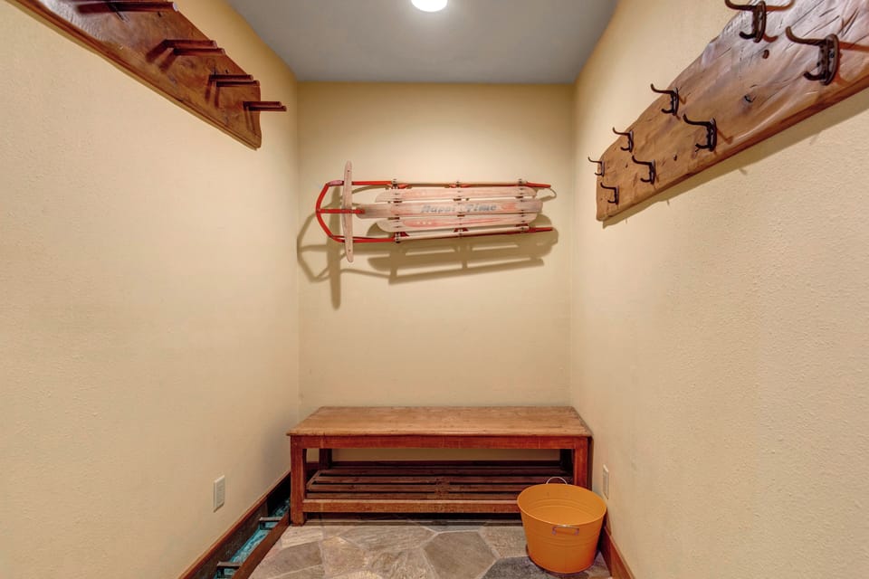 Your private mudroom awaits with wooden bench, plenty of hooks to dry clothes and hang gear.