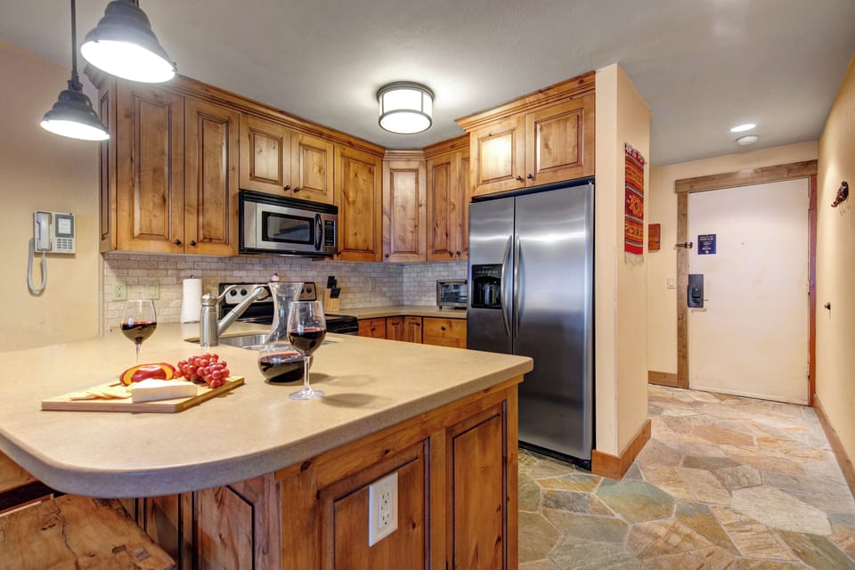Your gourmet kitchen features warm wood cabinets, granite counters, and stainless appliances.