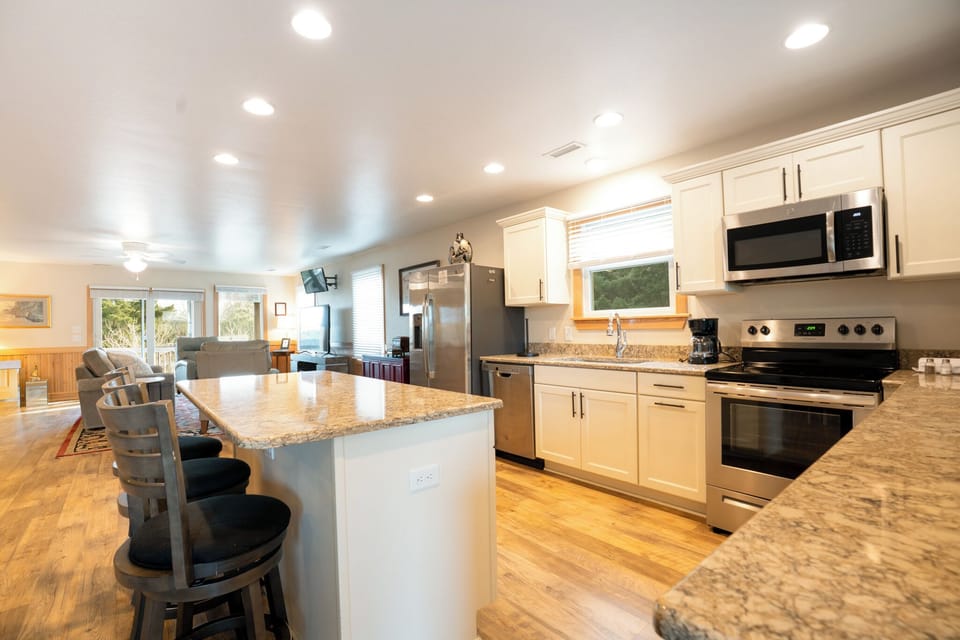 Your spacious gourmet kitchen features granite counters, stainless appliances, and a breakfast bar perfect for morning coffee and meal prep.