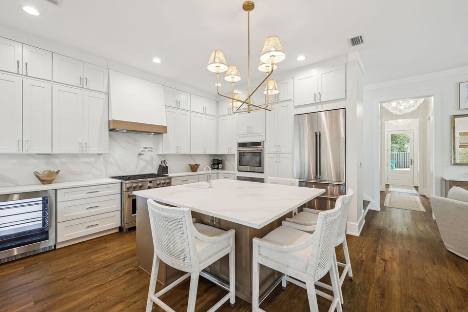Your chef-worthy kitchen features marble countertops, premium appliances, and elegant seating for memorable meals together.