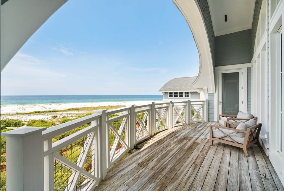 Step onto your private oceanfront balcony and soak in stunning beach views while relaxing in comfortable seating.