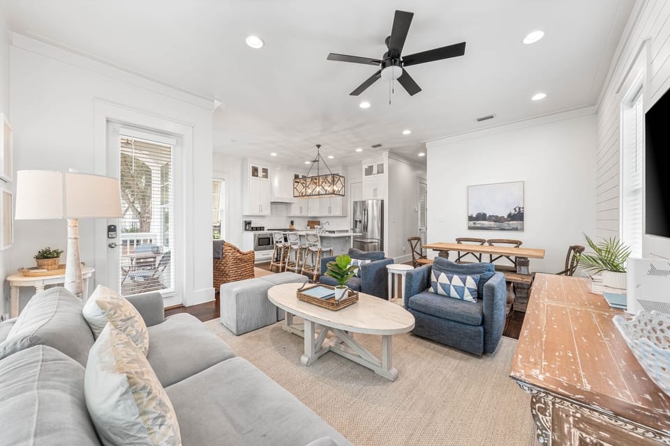 Relax in your bright, open-concept living space with comfortable seating, modern kitchen, and coastal charm throughout.