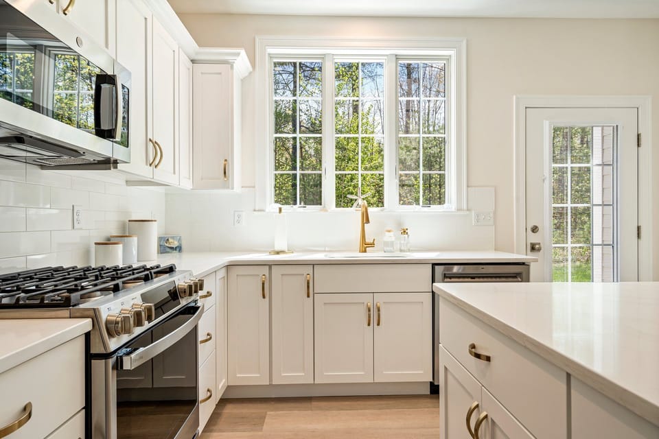 Open concept kitchen with stainless steel appliances, gas stove.