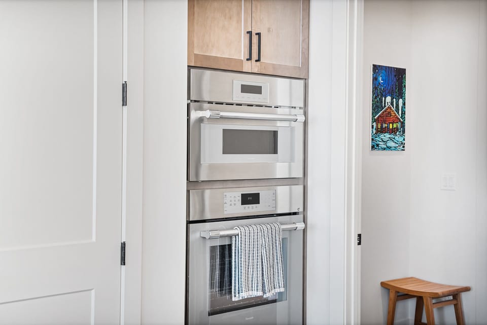 A professional Gas range and high end stainless steel appliances in this well stocked kitchen