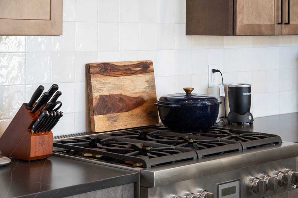 A professional Gas range and high end stainless steel appliances in this well stocked kitchen
