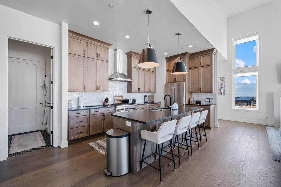 A professional Gas range and high end stainless steel appliances in this well stocked kitchen