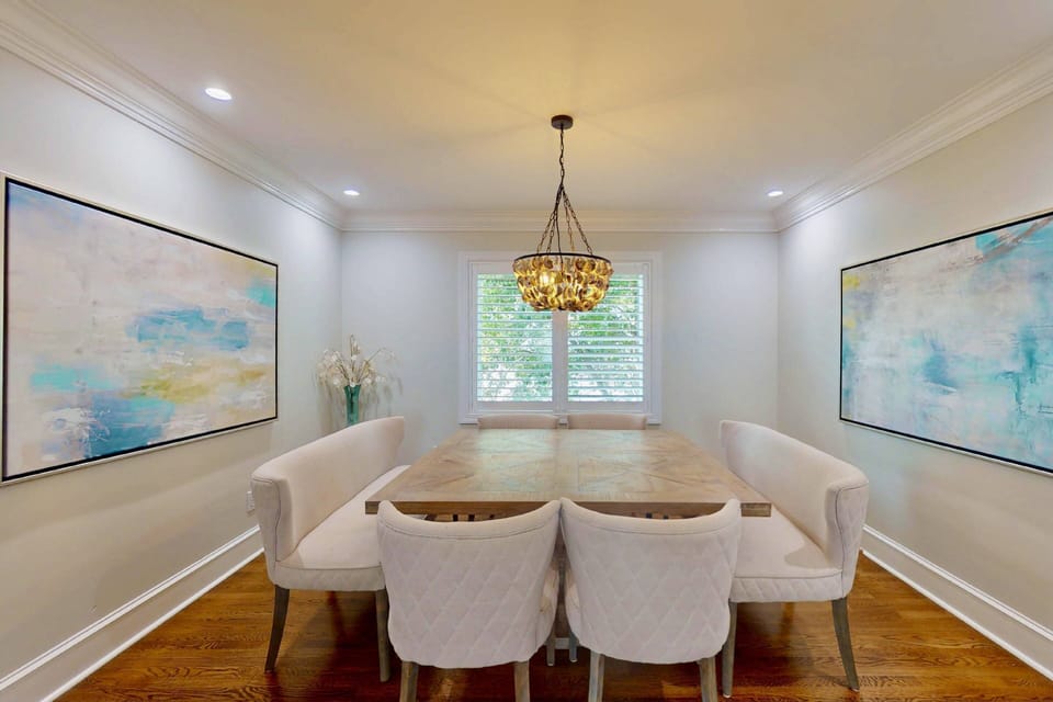 The dining room features an extra large table and stunning artwork