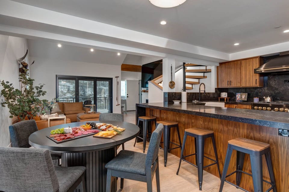 Upper Main 301: Gather around your modern kitchen island where warm wood meets sleek design, perfect for sharing charcuterie and creating memories.
