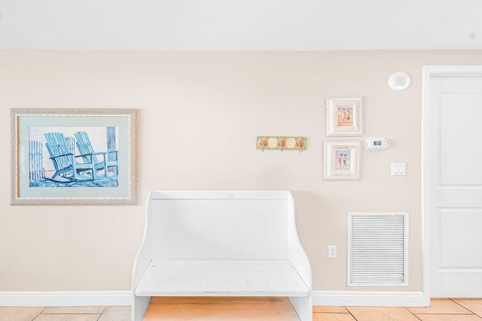 Relax in your thoughtfully decorated space with beach-inspired artwork and modern seating perfect for quiet moments.