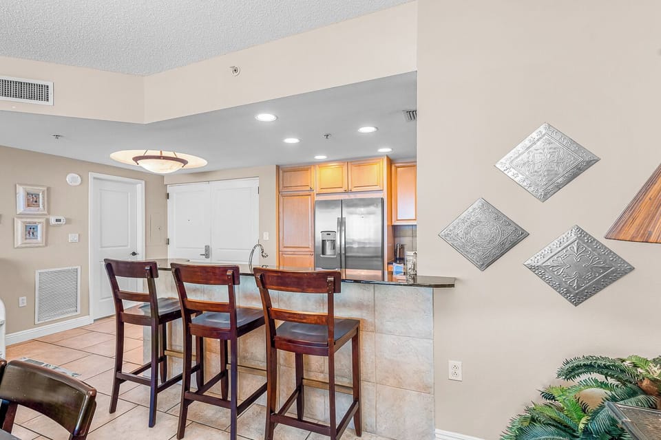 Your open kitchen features granite countertops, stainless appliances, and a breakfast bar perfect for morning coffee or casual meals.