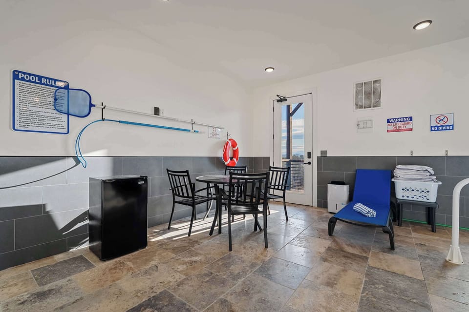 Mini Fridge and lounge area in pool room. 