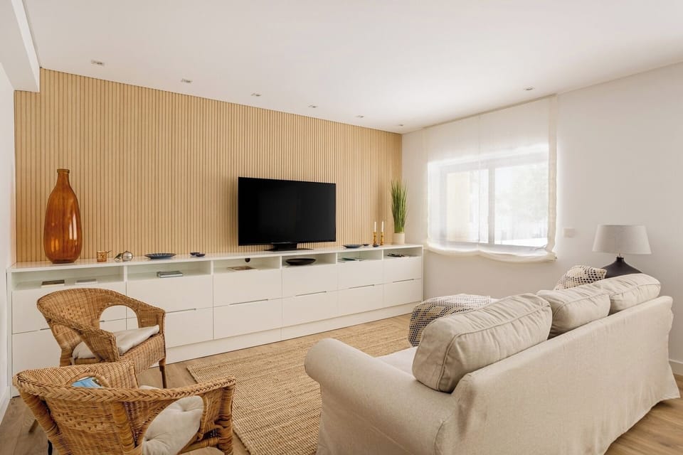 Living room with a comfortable seating area, TV, AC and Dining table for 6. 