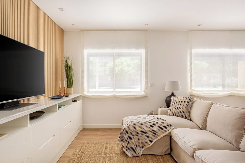 Living room with a comfortable seating area, TV, AC and Dining table for 6. 