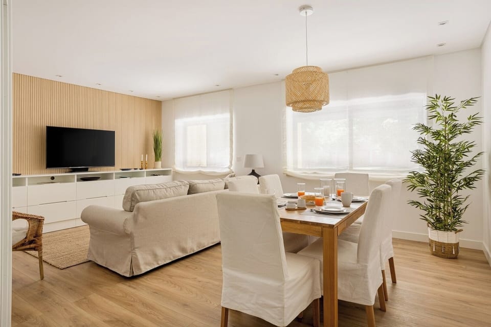 Living room with a comfortable seating area, TV, AC and Dining table for 6. 